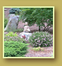 Stone Buddha meditates among flowers