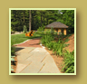 Hostas and Daylilies flank flagstone walkway