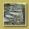 Side view of native stone staircase and retaining wall